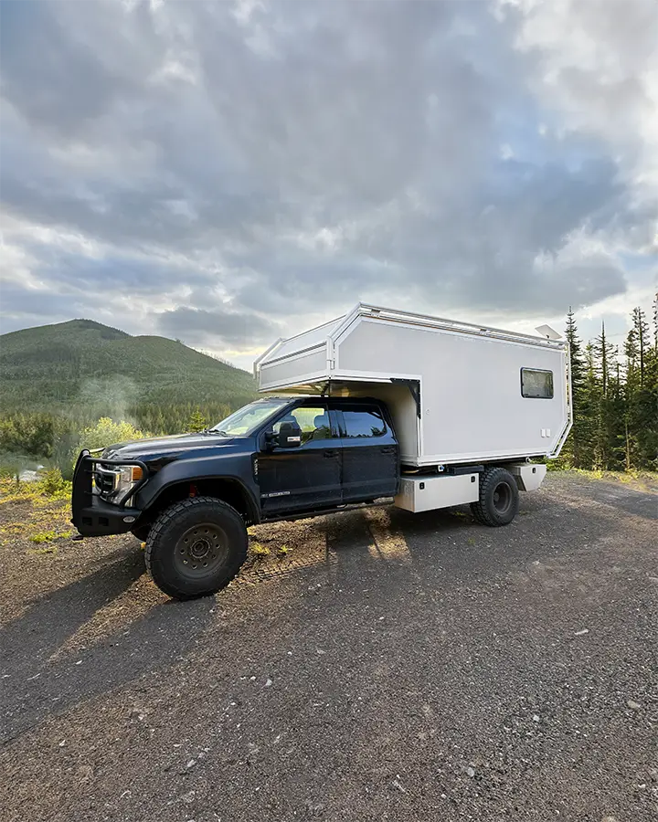 Expedition Cabover Camper in forest.