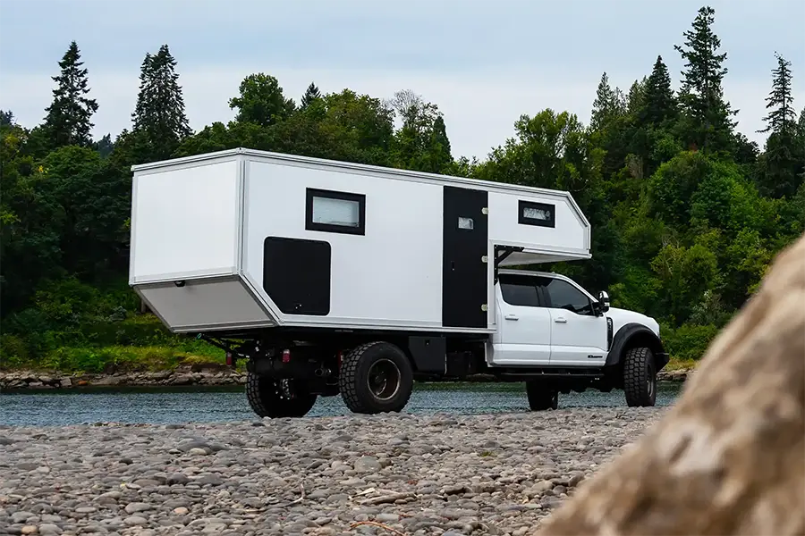 Expedition Cabover Camper at river.